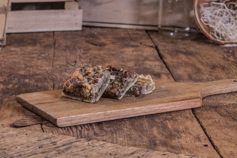 Thumbnail: Three squares on a wood cutting board Wholesale Sticky Bun Flavor Explosion Pretzels Tabora Farms