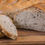 Thumbnail: Freshly sliced bread on wooden cutting board, close-up shot of baked goods.