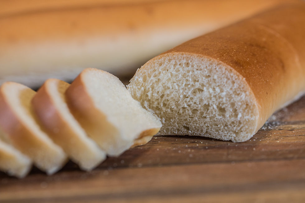 Thumbnail: Sliced loaf of bread, close up on wooden cutting board.