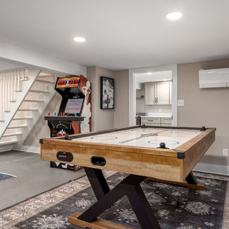 Furnished basement with air hockey table.
