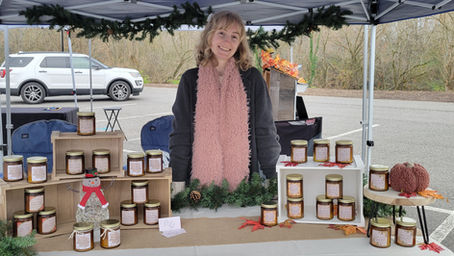 woman in a booth selling candles