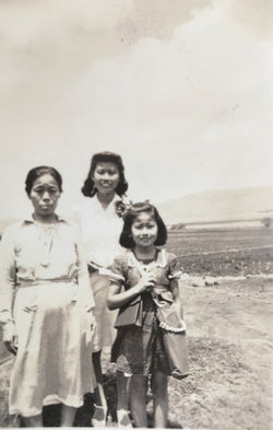 Betty on her way to school in Hawaii carrying her gas mask.