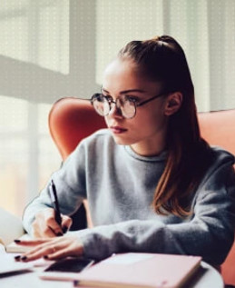 Focused student studying with laptop and notebook