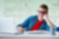 Student studying at desk with laptop and books