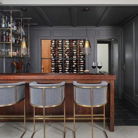Skye Metal Frame Bar Stools in front of wine storage locker.