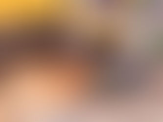 Stump grinder cutting a tree stump with wood chips flying.