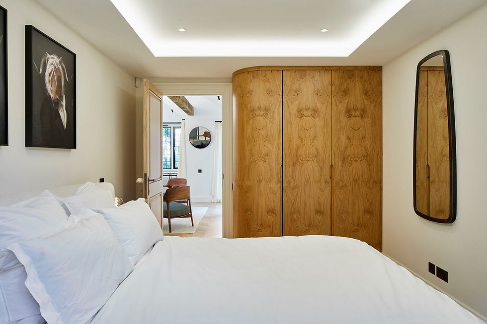 Luxury Guest Bedroom by Open Volume Studio showing a book matched veneer wardrobe and a contemporary modern design with a light recess in the ceiling