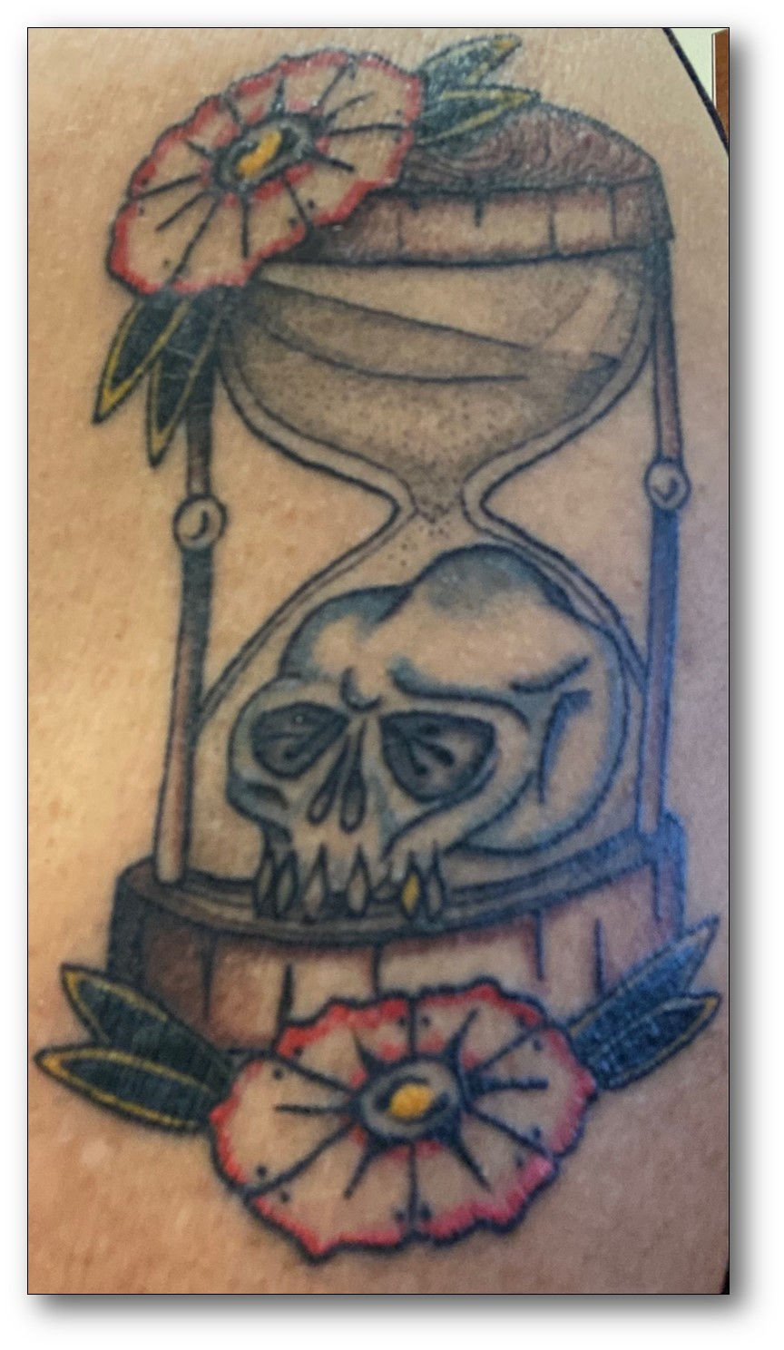 Flowers designate life; hourglass, time; and the skull, our mortality and the final act on this side, physical death.