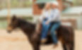 Cowboy and bowgirl sitting on their horse at their Gettysburg, PA farm wearing Back to Basics Western Wear clothing from head to toe