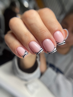 Pink nails with black and silver striped French tips