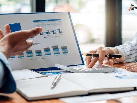 Small business owner reviewing financial reports and bookkeeping records