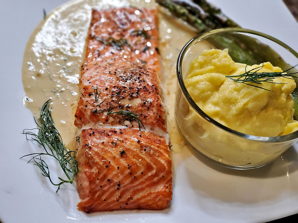 Cedar Planked Grilled Steelhead Trout with Creamy Dijon Dill Garlic Sauce.