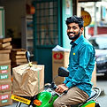 a indian boy doing delivery of swiggy.jp