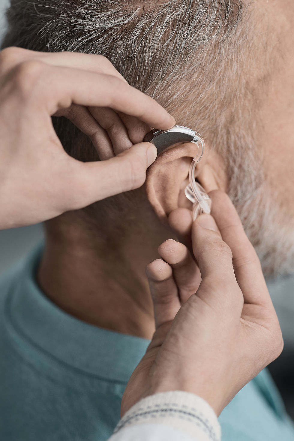 audiologist-installing-hearing-aid-on-ear-of-elder-2025-07-23-17-25-35-utc.jpg