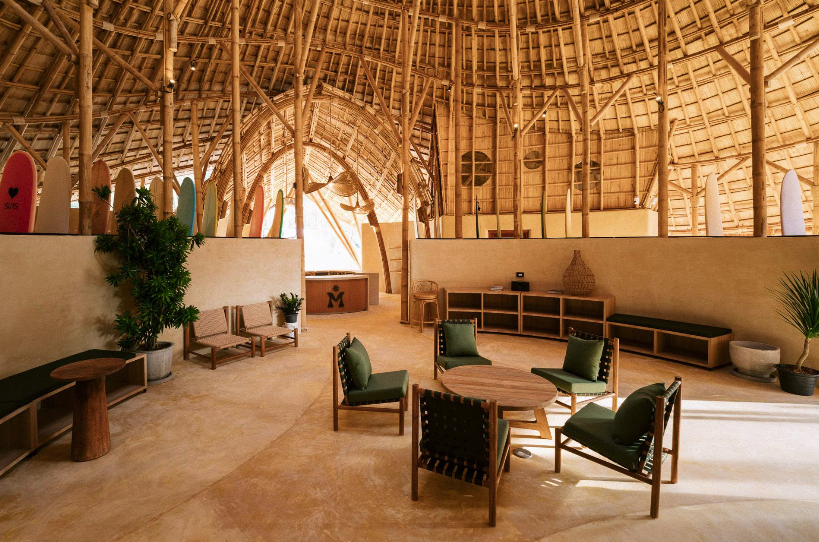 Bamboo surf lounge with surfboards and wooden chairs