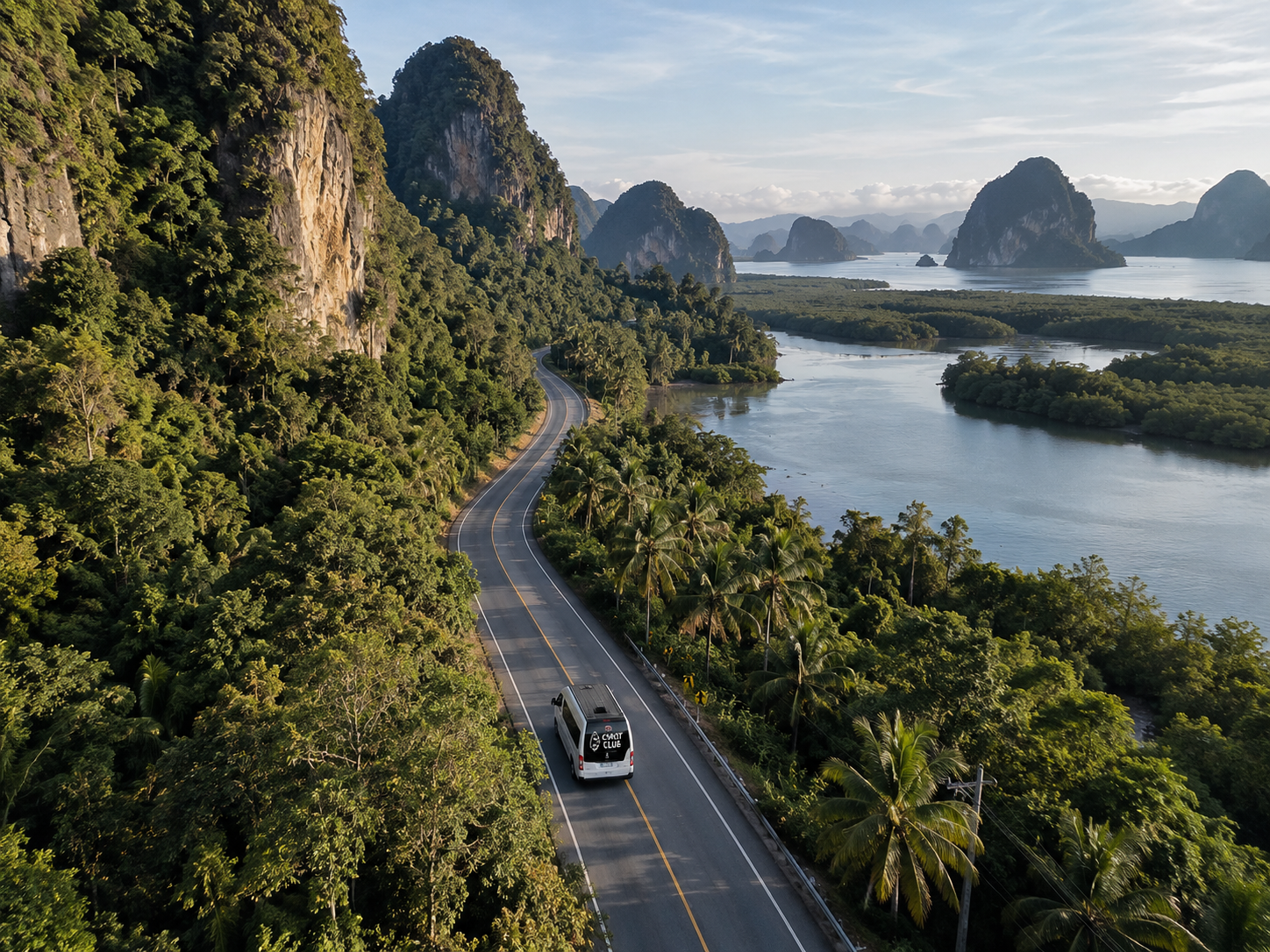 Coast Club van driving along a coastal road past limestone cliffs