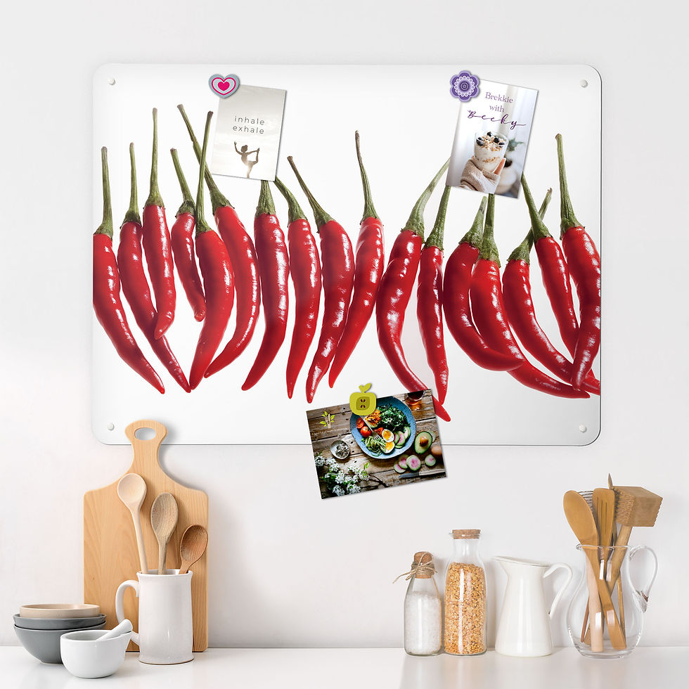 A magnetic board featuring a photograph of red chilli peppers in a row with postcards and flyers about health attached with fridge magnets