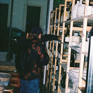Guests choosing natural wine from shelves of handmade ceramics and bottles at Studio Marvila in Lisbon.