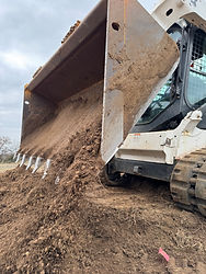 Bobcat Skid steer backfilling culvert pipe trench line in Seminole, Ok