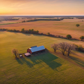 Drone shot of rural farm property with iconic red barn surrounded by lush agricultural fields at dusk
