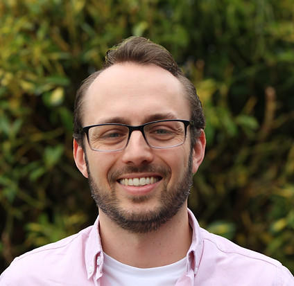 Our Team member Tom; Smiling man wearing glasses