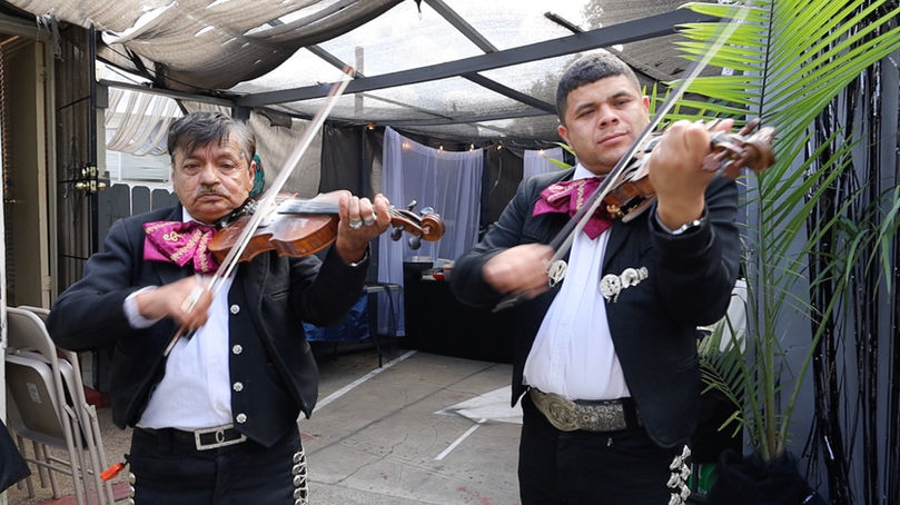 Mariachi Violinists performing at a backyard party