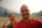 A couple poses in front of the camera with dusty faces.