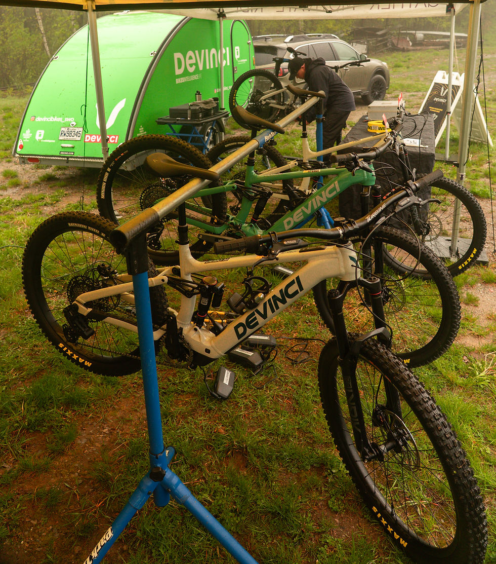 A mechanic works on a bike while the others are on display.