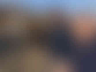 three people standing in a vineyard