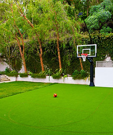 a basketball court using artificial turf flooring with a muted 3-point line and key