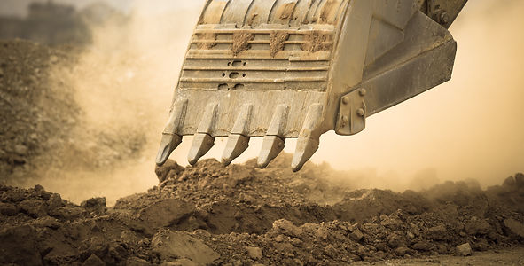 Excavator working with red soil and dusty_edited.jpg