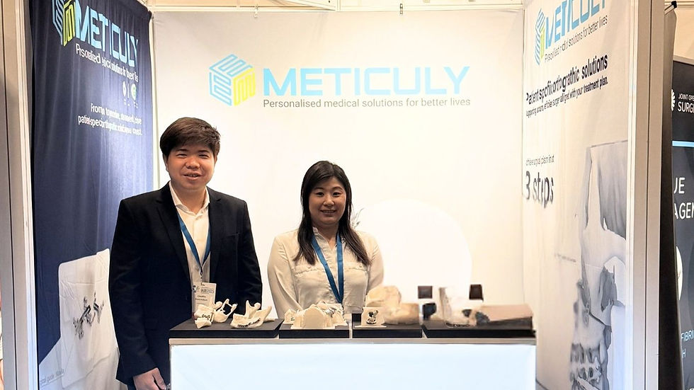 Asst Prof. Dr. Chedtha Puncreobutr and Chetarpa Yipyintum, PhD were standing at booth with mandible reconstruction patient specific implants were on the counter.