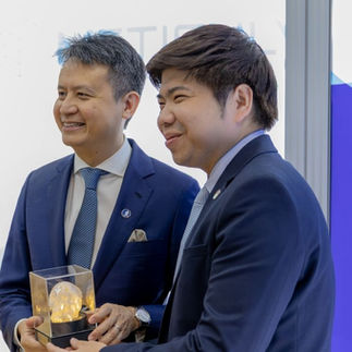 Mr. Daren Tang, Director General and Asst. Prof. Dr. Chedtha Puncreobutr are taking photo holding a gift from Meticuly.