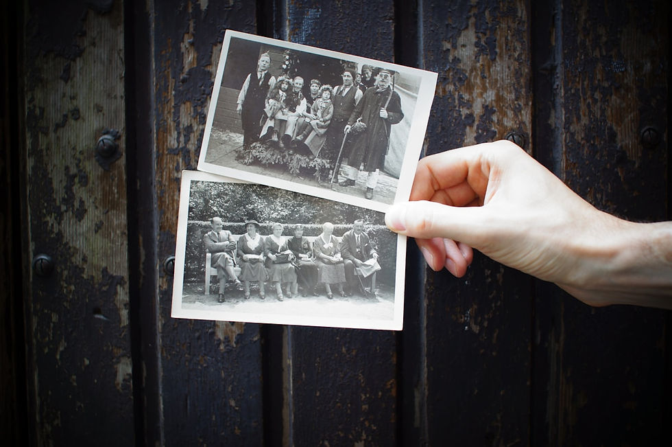 Hand holding old black and white family photographs