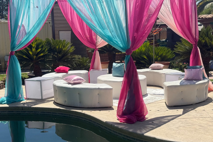 colorful poolside drapes shading a lounge area.