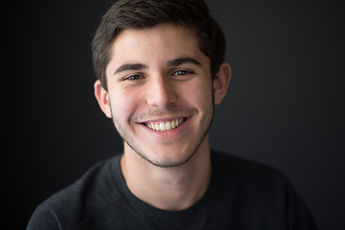 A slight deviation from my go-to headshot (caught at the start of a laugh).