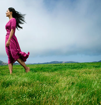 Woman on grassy mountaintop