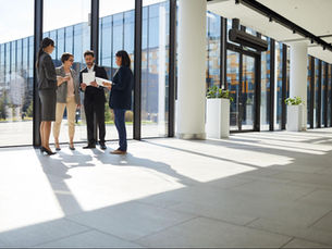 Realtors showing a vacant commercial property to prospective buyers.