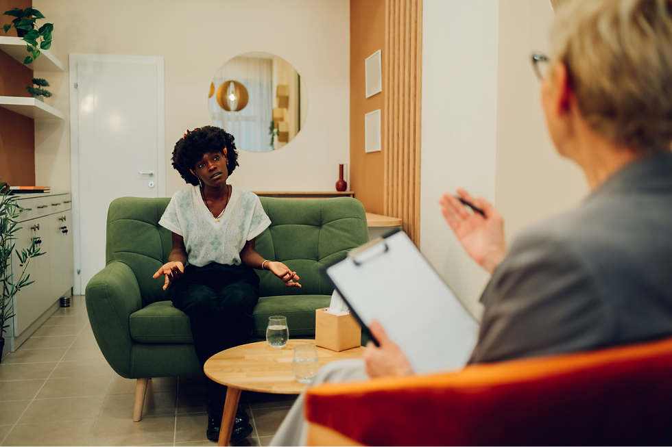 A woman sitting down and receiving therapy.