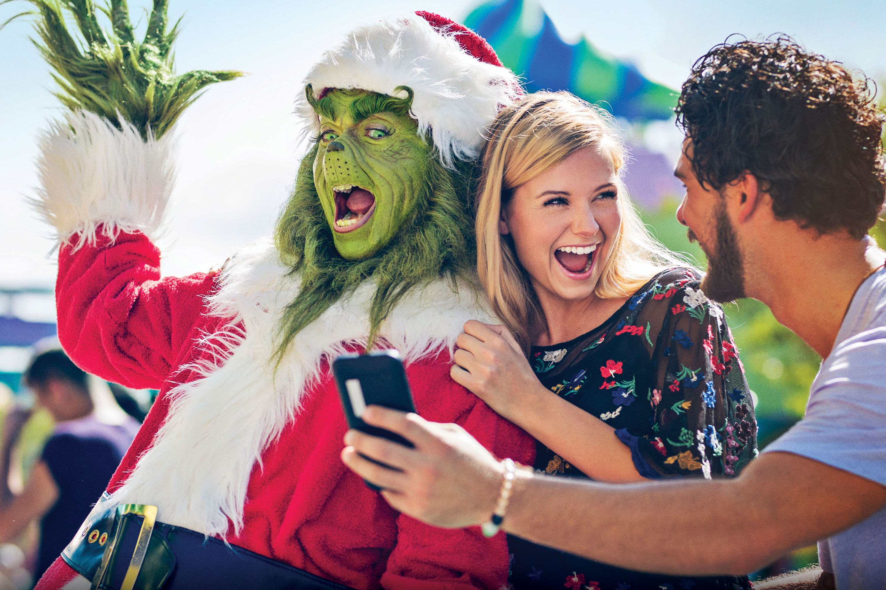 Family taking a selfie with the Grinch during Grinchmas at Universal Studios Hollywood