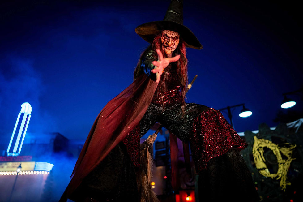 Witch character with outstretched hand at night during Six Flags Fright Fest Magic Mountain