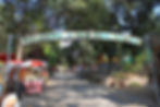 Oak Tree Village" sign in an apple orchard setting near Los Angeles, perfect for apple picking with families
