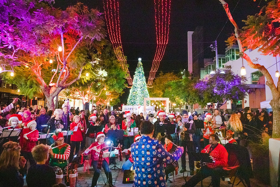 Families and carolers at a free Christmas tree lighting in Los Angeles on the Third Street Promenade in Santa Monica