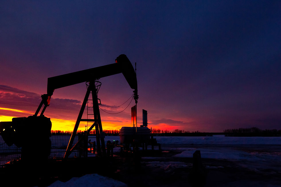 Wide angle view of an oil rig against a sunset sky