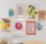 wall showing colourful art prints in bold graphic styles with type and illustrations on some