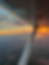 Aerial view from a plane wing during a sunset flight.