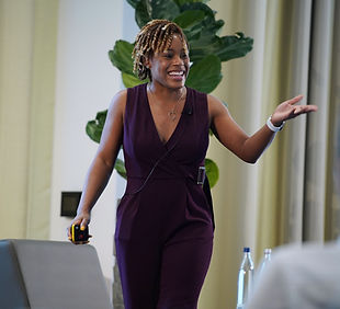 Tanesha Moody speaking with a group in a bright meeting room