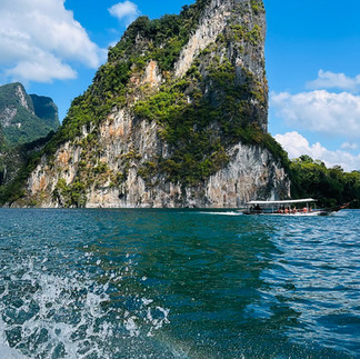Limestone cliffs coming out of the lake with splashes of water
