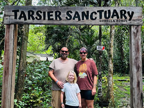 Mum, Dad and Child under Tarsier Sign in Bohol
