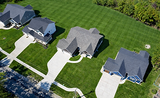 Suburban homes with lush lawns.png